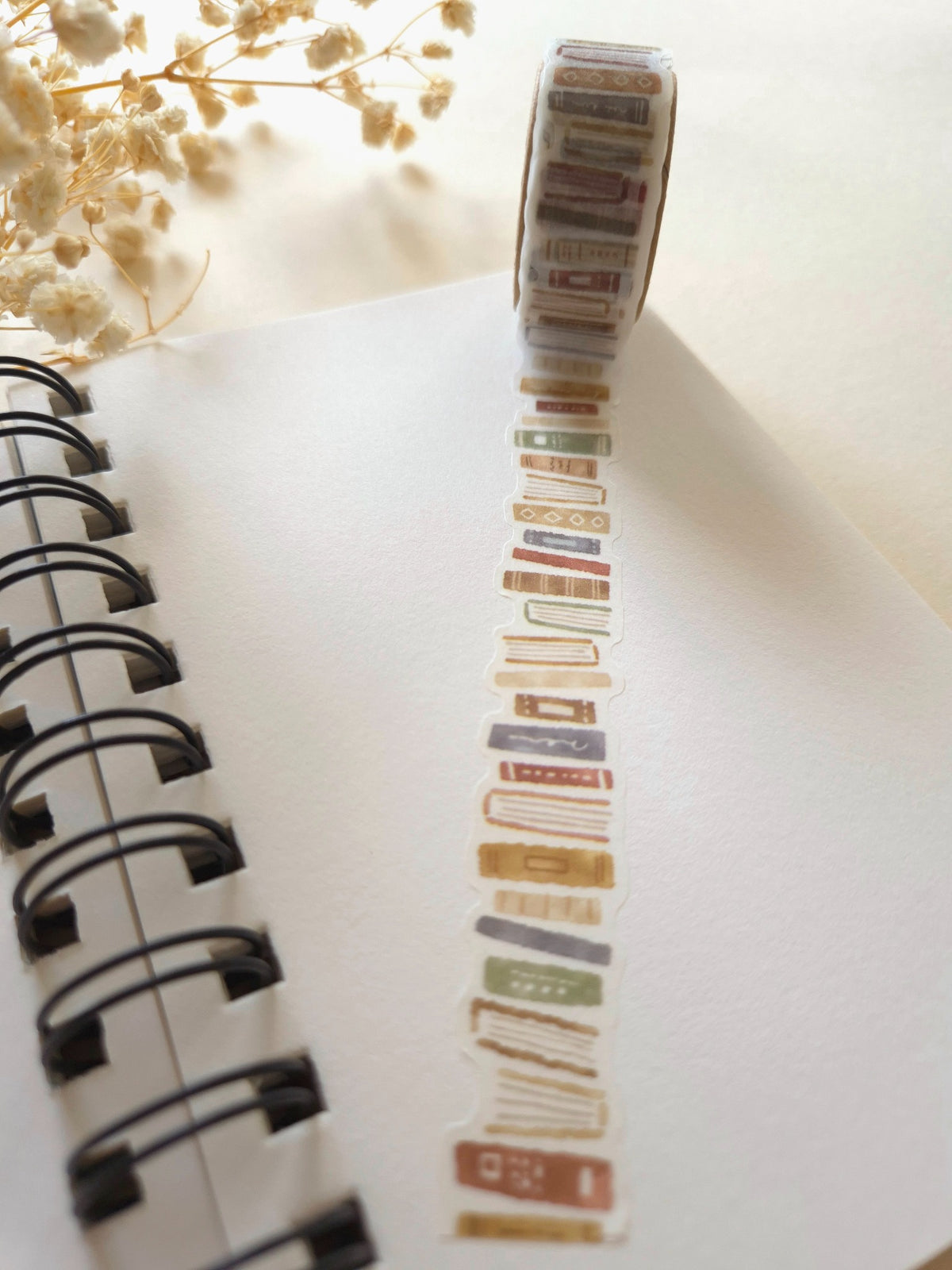 Mind Wave Book Brown die-cut masking tape unrolled across a notebook page with dried flowers