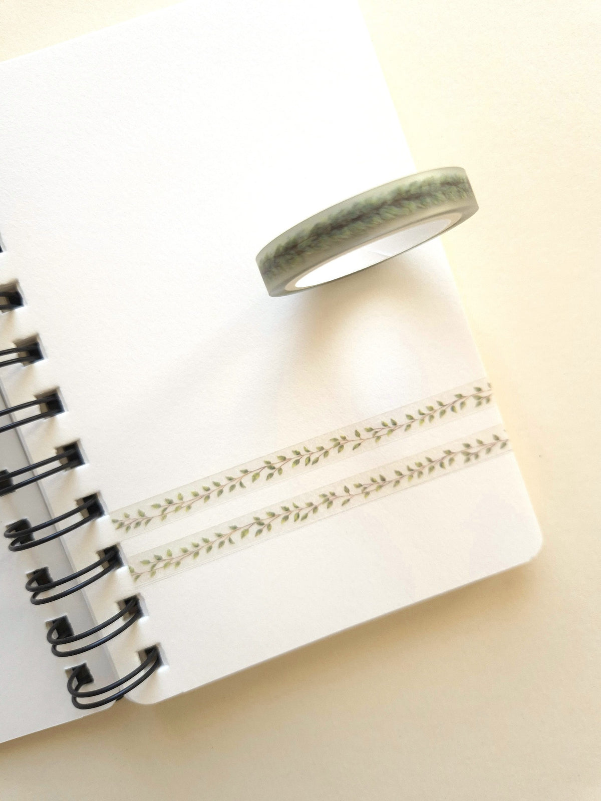 Mind Wave Clear Tape Leaf Line 7mm roll with delicate green leaf design on a notebook