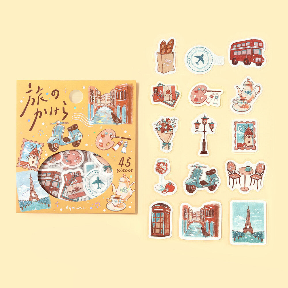 BGM Fragments of a Journey To the World flake sticker set showing 15 travel-themed designs beside the orange package