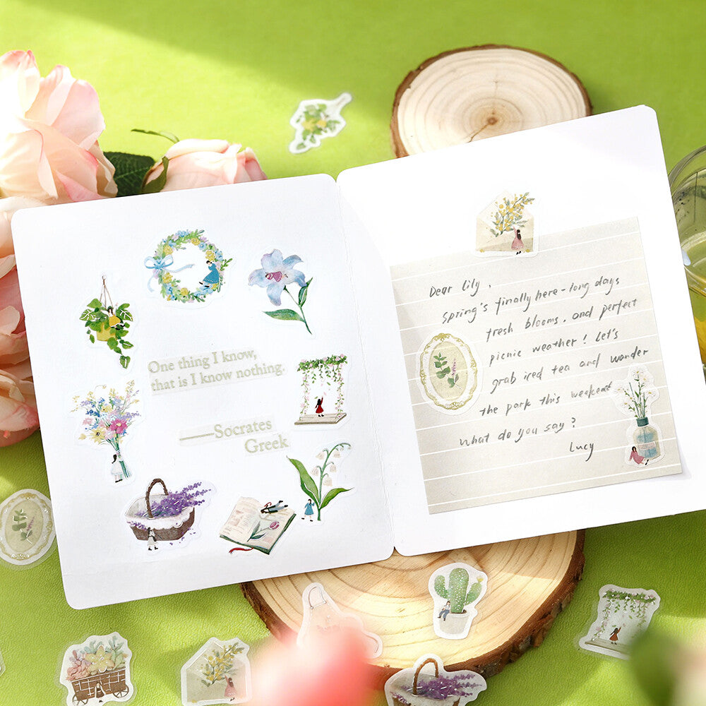 BGM Petit Story Gardening flake stickers arranged in an open journal with floral and plant motifs