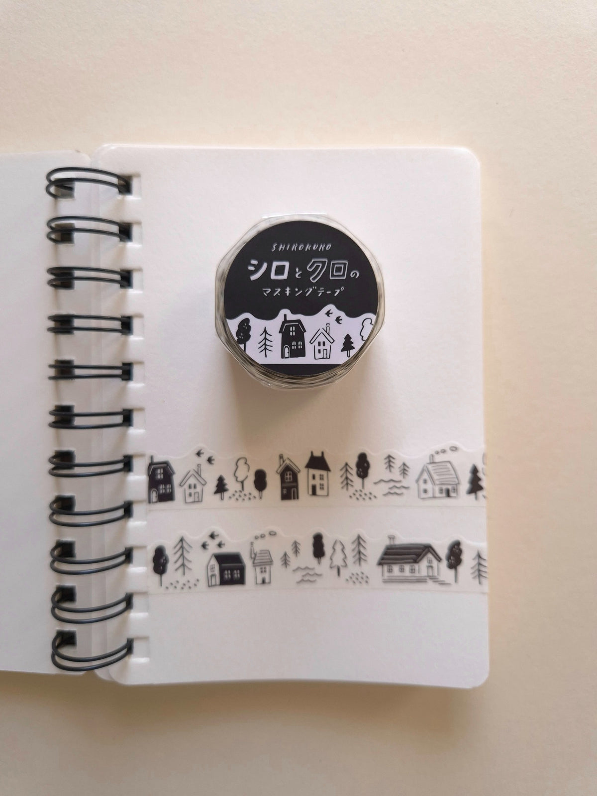 Mind Wave Black & White Lifestyle die-cut masking tape roll displayed with two sample strips on a white notebook