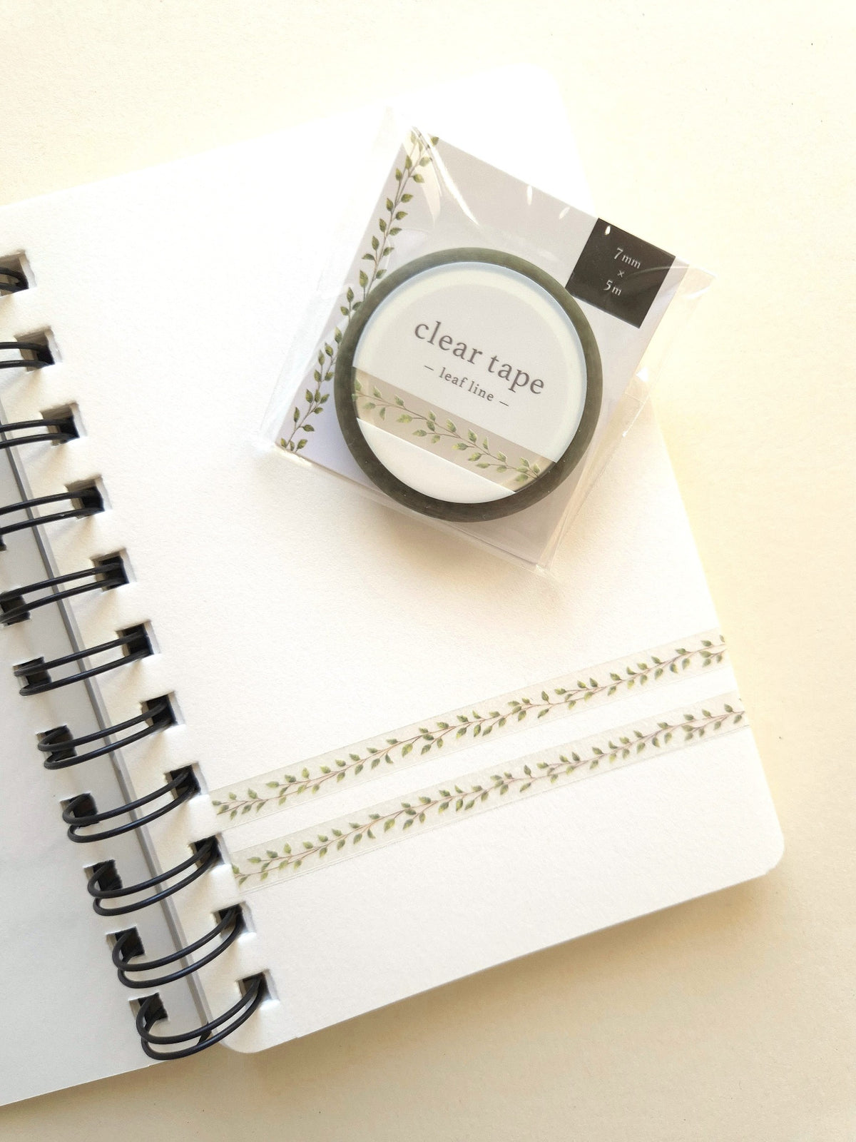 Mind Wave Clear Tape Leaf Line 7mm in packaging with leaf tape samples on a notebook