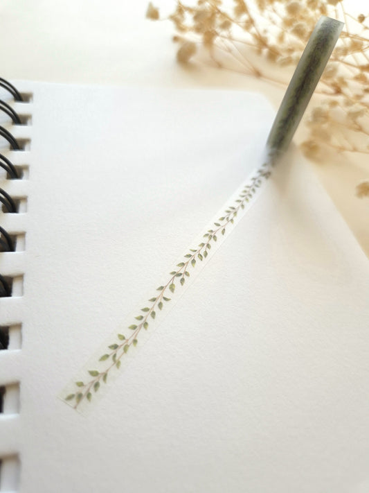 Mind Wave Clear Tape Leaf Line 7mm unrolled across a notebook with botanical leaf pattern