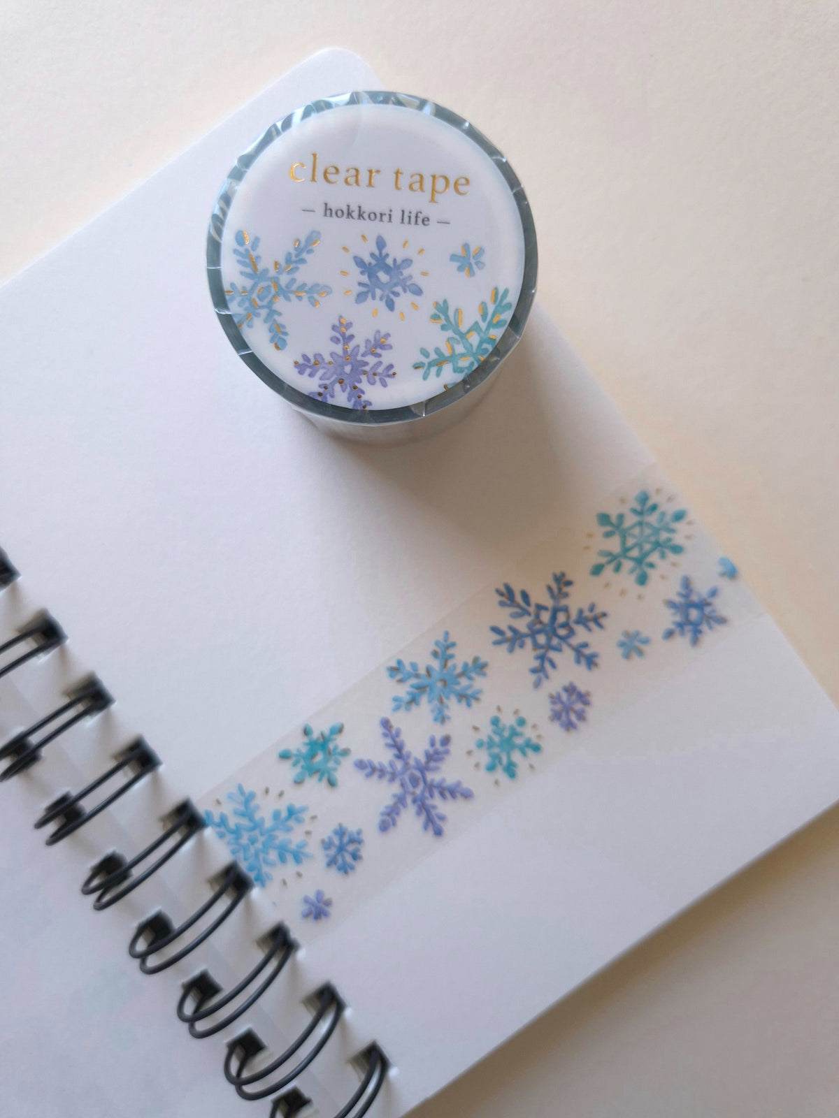 Mind Wave Hokkori Life Clear Tape with Foil – Kessho shown with snow-crystal design on a notebook