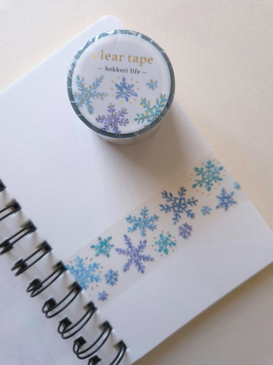 Mind Wave Hokkori Life Clear Tape with Foil – Kessho shown with snow-crystal design on a notebook