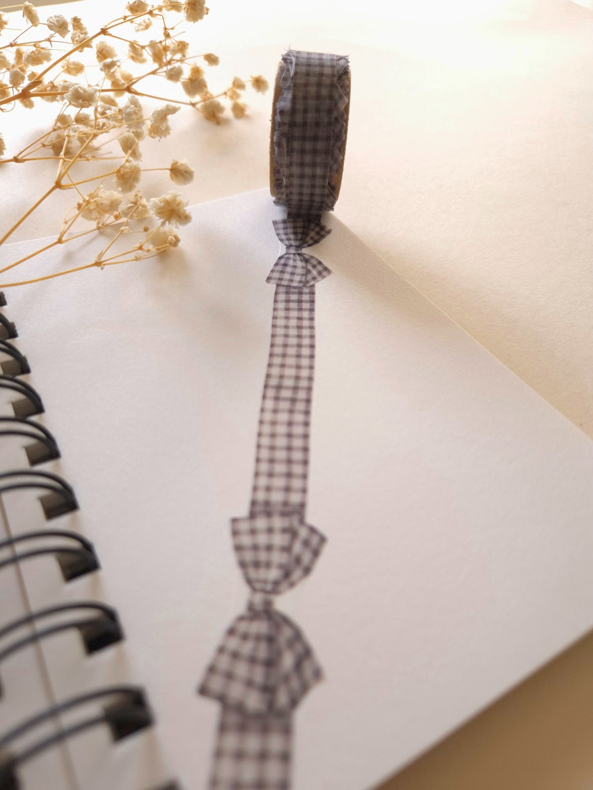 Mind Wave Gingham Check Gray ribbon die-cut masking tape unrolled on notebook