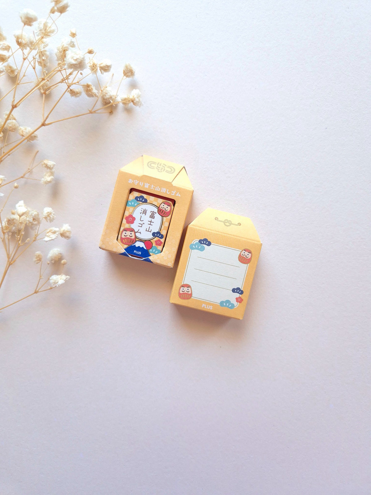 PLUS AIR-IN Mt. Fuji Eraser Daruma Yellow front and back packaging on cream background