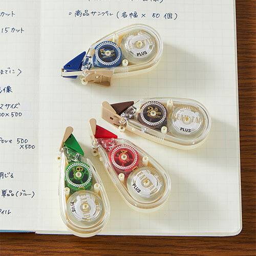 PLUS Whiper Petit Cream Correction Tape in multiple colours shown on notebook paper