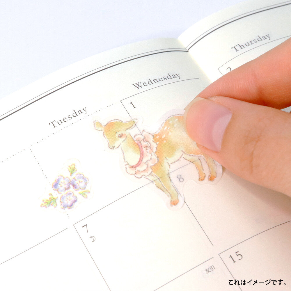 SAIEN Mon Favori masking sticker being placed in a planner, showing the soft translucent washi finish